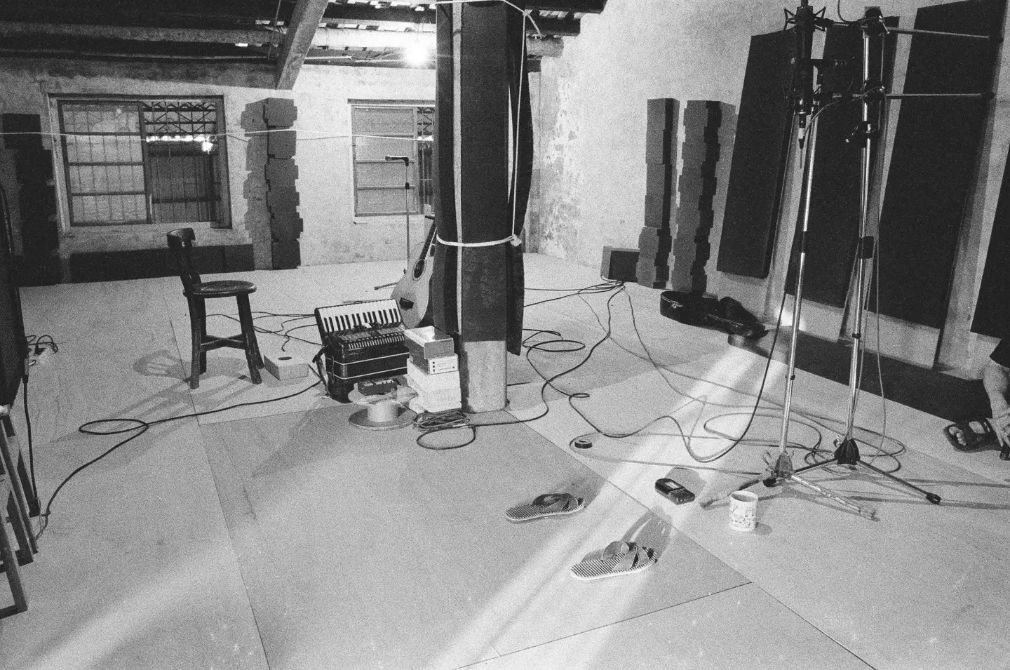 1998 年，林生祥與夥伴在沒有隔音設備、最多只能錄八軌的美濃「菸樓錄音室」裡，手工錄製完成反水庫運動相關作品。（攝影／鍾明光）